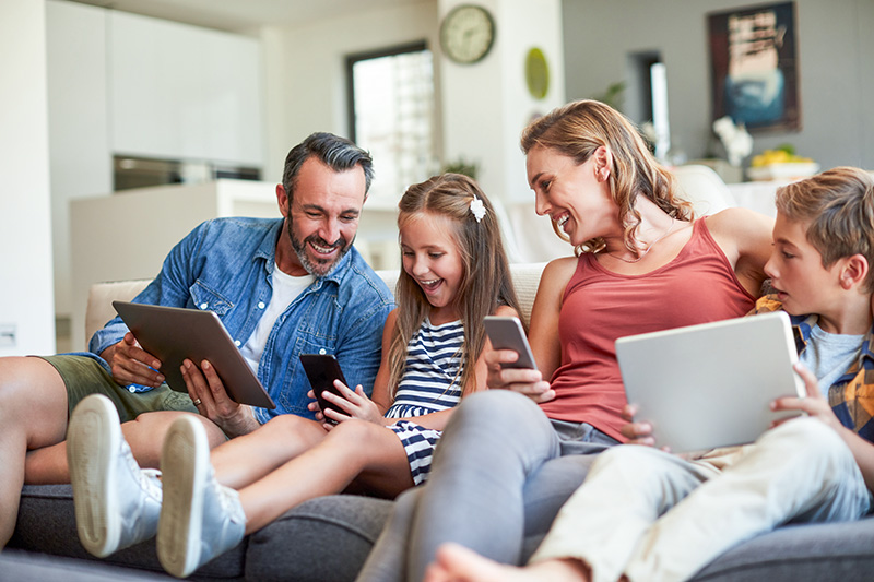 Family enjoying wireless devices, showcasing seamless internet access in rural areas.