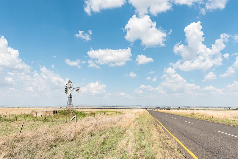 rural-farm-with-windmill Scenic rural farm with a windmill, representing the essence of West Texas landscapes.